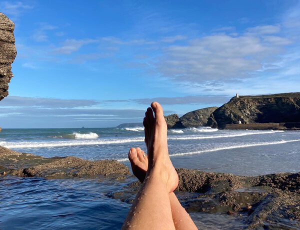 Lady Bassett's baths on Portreath beach with blue skies and looking out onto the waves.