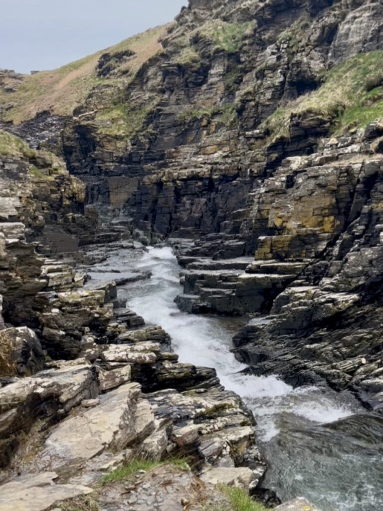 Photo of Rocky valley where the river winds through dramatic cliffs to the sea. 